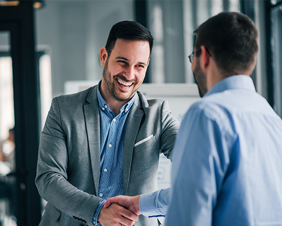 Coworkers shaking hands and smiling