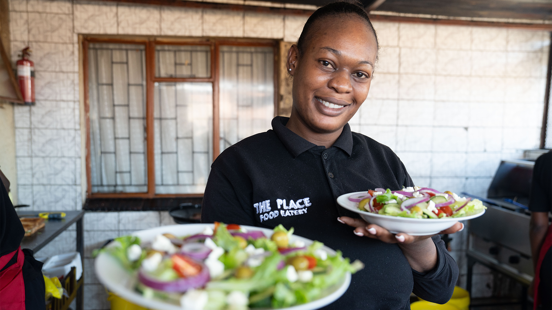 Chef holding 2 salads